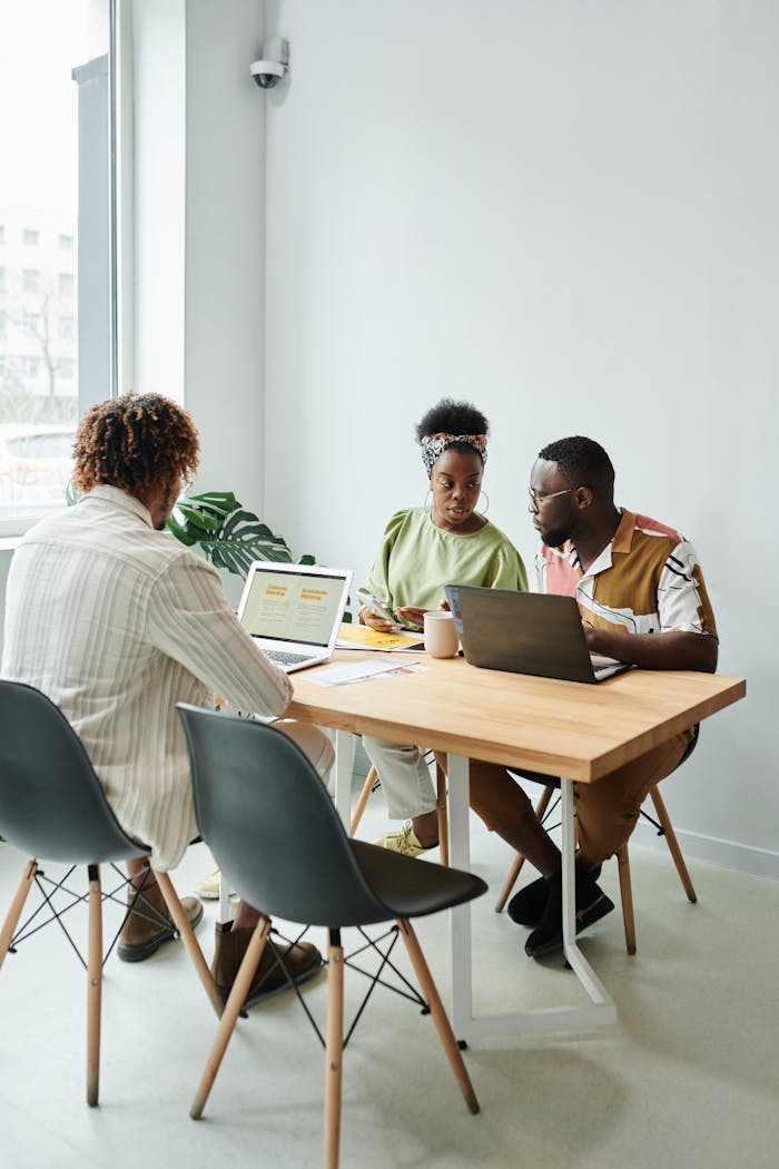 Professional meeting in a modern office setting with diverse team discussing online marketing strategies.